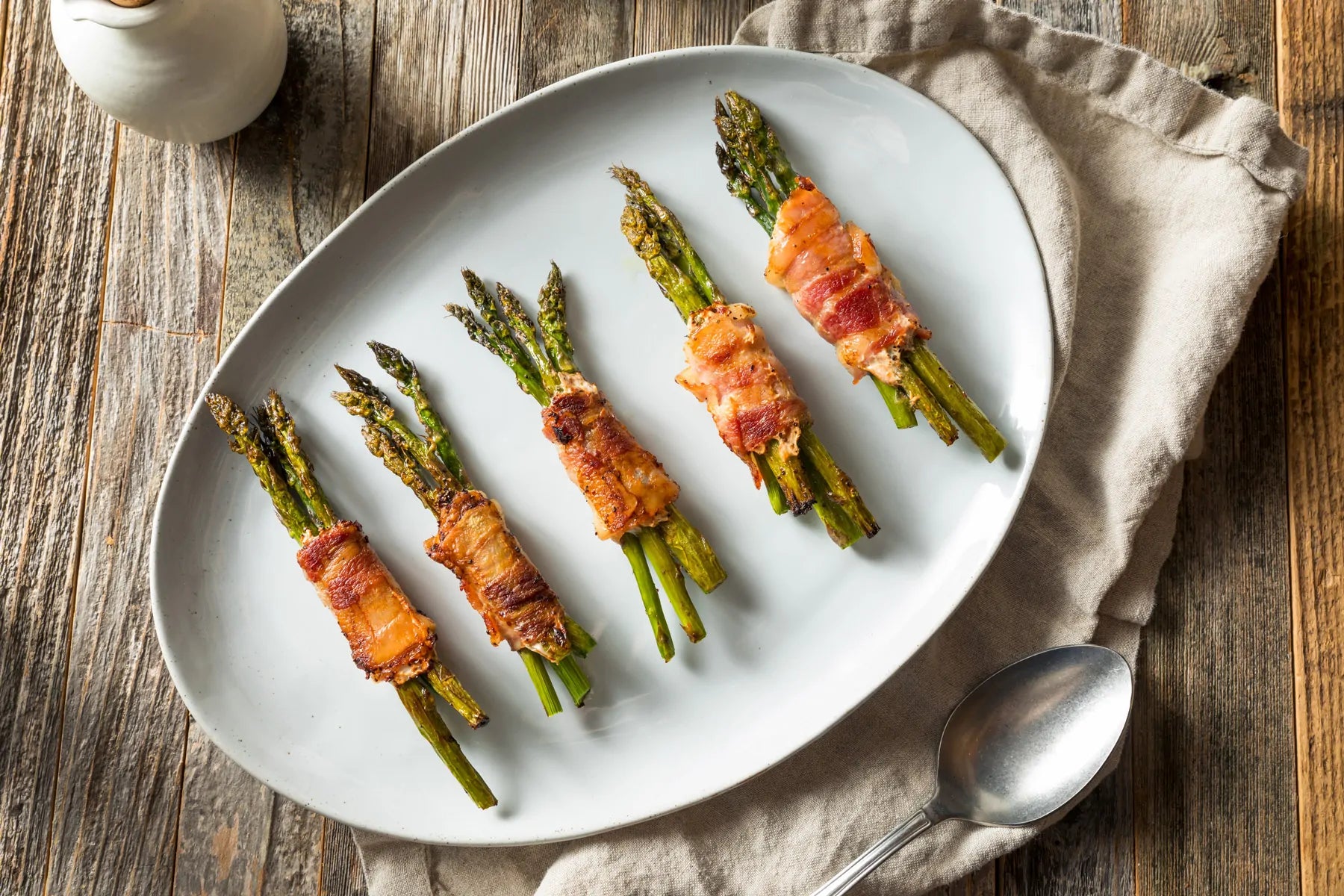 Plate with green asparagus wrapped in turkey bacon
