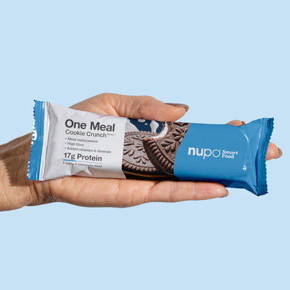 Nupo One Meal Cookie Crunch bar in hand – convenient meal replacement on the go